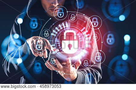 Man Hacker Finger Touch Tablet In Hand, Glowing Lock Circuit. Concept Of Cyberattack And Protection