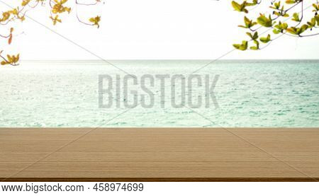 Wood Table On Blue Sea And Green  Leave With Bue Sky Background.montage Mockup Tabletop On Water Oce