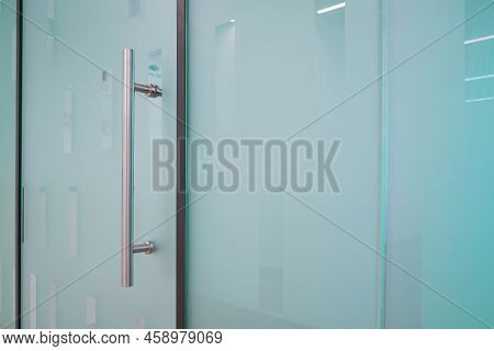 Doorknob On Close Glass Door In Office. Detail Of Contemporary Doorknob For A Glass Door In Office