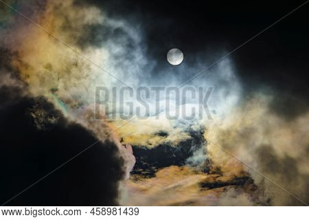Diffraction Of Light On Drops Of Supercooled Water In Clouds, Rainbow Clouds Against The Blue Sky In
