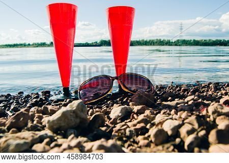 In Summer, Two Red Glasses Of Sparkling Champagne Or Prosecco Bay  Pebbly Beach.