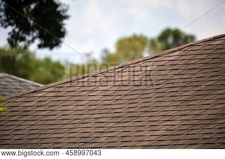 Closeup Of House Roof Top Covered With Asphalt Or Bitumen Shingles. Waterproofing Of New Building