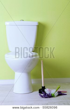 White toilet bowl and cleaner things in a bathroom