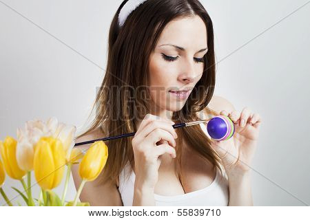 Girl painting easter eggs