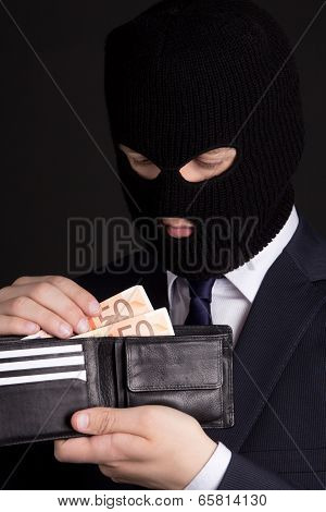 Corruption Concept - Man In Business Suit And Mask Holding Leather Purse With Euro Banknotes