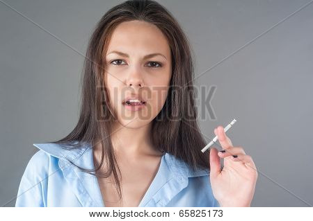 Attractive young brunette woman with cigarette