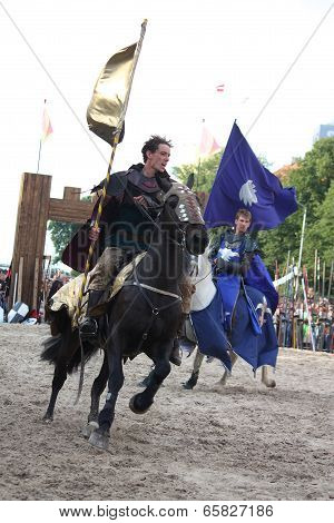 Riga, Latvia - August 21: Member Of The Devils Horsemen Stunt Team Riding Horse And Holding Flag Dur