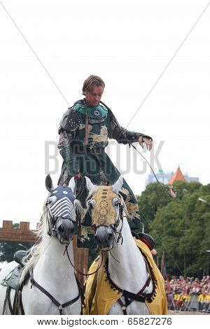 Riga, Latvia - August 21: Unidentified Man From The Devils Horsemen Stunt Team Riding Two White Hors