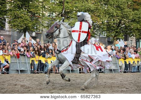 Riga, Latvia - August 21: Member Of The Devils Horsemen Stunt Team Riding White Horse During Riga Fe
