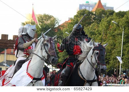 Riga, Latvia - August 21: Two Members Of The Devils Horsemen Stunt Team Fighting With Swords During