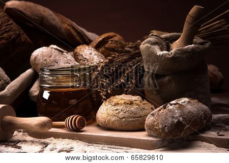 Fresh Bread And Wheat On The Wooden Table
