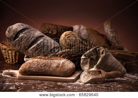 Fresh Bread And Wheat On The Wooden Table