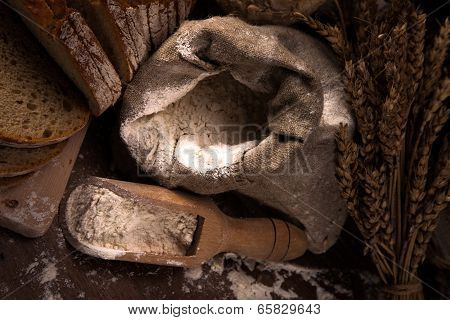 Fresh Bread And Wheat On The Wooden Table