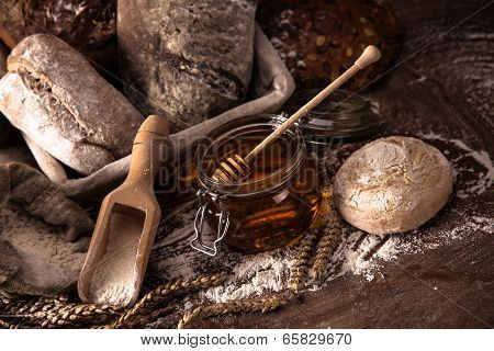 Fresh Bread And Wheat On The Wooden Table