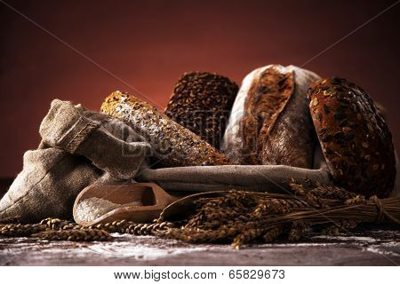 Fresh Bread And Wheat On The Wooden Table
