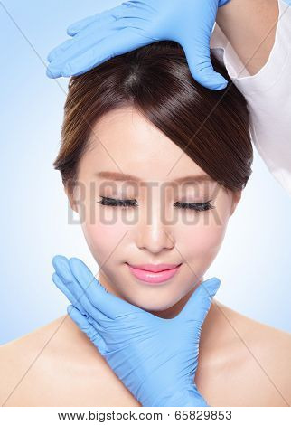 Female face with plastic surgery glove