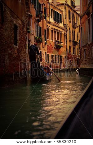 View of gondola with gondolier at narrow street of city. Venice