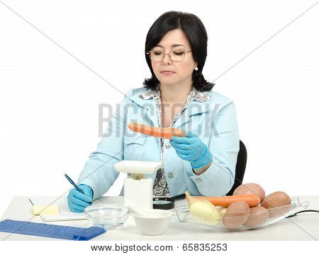 Expert Weighing A Carrot In Laboratory