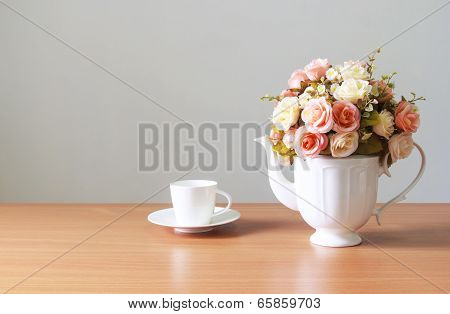 Romantic  A Bouquet Of Roses In White  Jug With Coffee Cup On Wooden Table  And Gray Concrete Walls