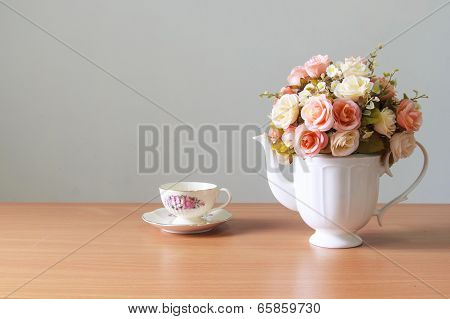 Romantic  A Bouquet Of Roses In White  Jug With Coffee Cup On Wooden Table  And Gray Concrete Walls