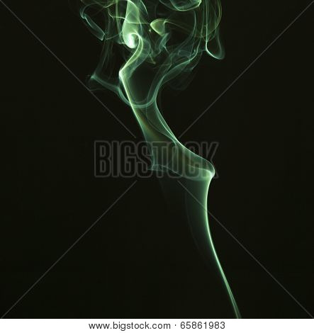 Green colored smoke on a black background.