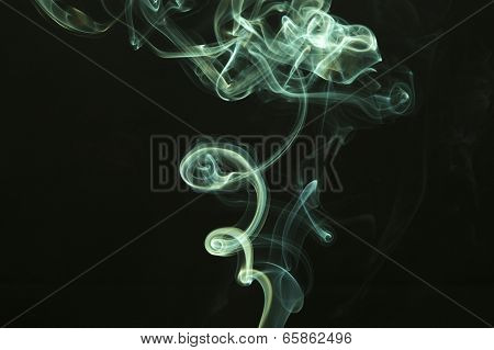 Green colored smoke on a black background.