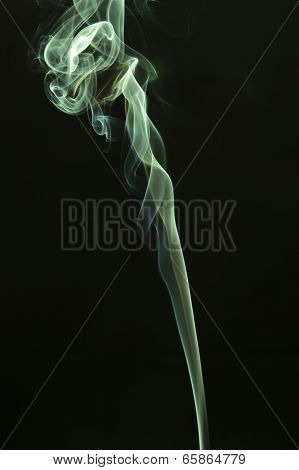 Green colored smoke on a black background.