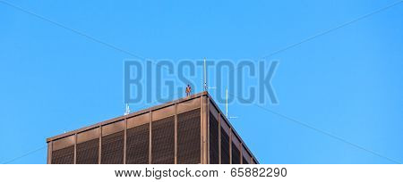 Iron Statue Of Man From Artist Antony Gormley On The Roof Of A Manhattan Skyscraper