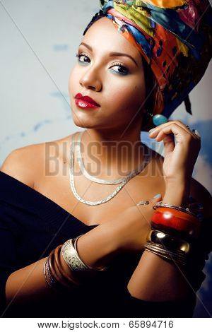 beauty bright african woman with creative make up, shawl on head like cubian woman