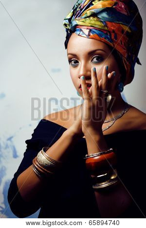 beauty bright african woman with creative make up, shawl on head like cubian woman