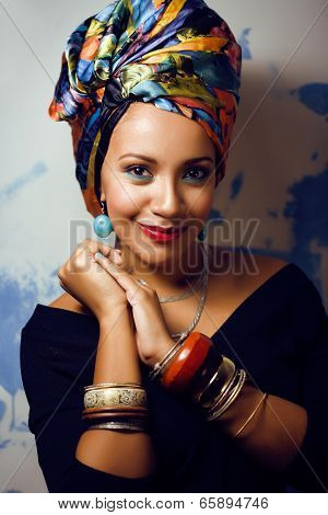 beauty bright african woman with creative make up, shawl on head like cubian woman