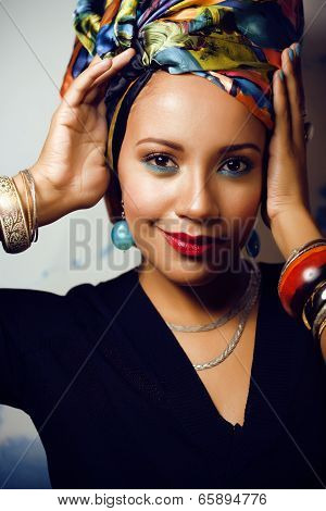 beauty bright african woman with creative make up, shawl on head like cubian woman