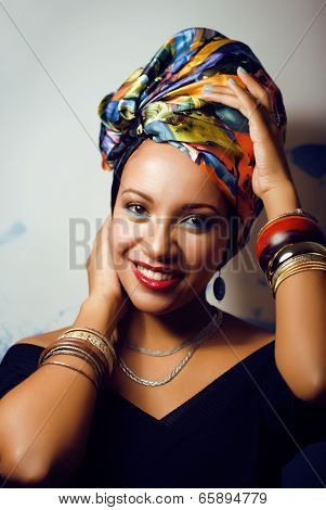 beauty bright african woman with creative make up, shawl on head like cubian woman