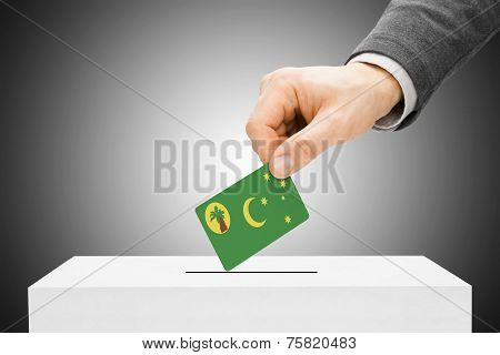 Voting Concept - Male Inserting Flag Into Ballot Box - Cocos (keeling) Islands