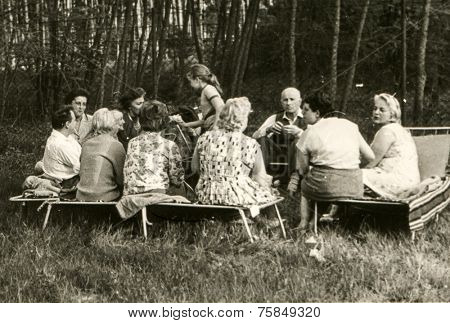 USTRONIE, POLAND, CIRCA SIXTIES: Vintage photo of group of people parting in garden