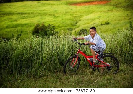 Asian Boy Riding On His Bycicle