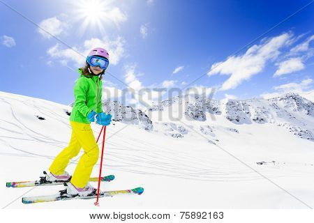 Ski, winter fun - lovely skier girl enjoying skiing