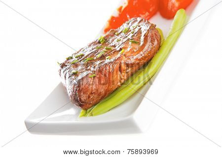 beef meat served with tomato on white porcelain