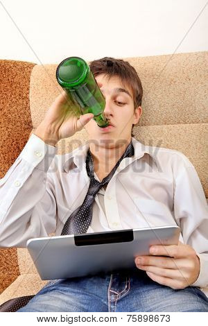 Teenager With A Beer And Tablet