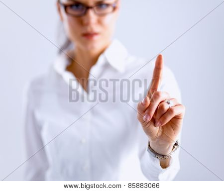 Woman touching an imaginary screen with her finger. 