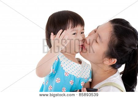 Asian Mother Carrying And Smooching Her Daughter On White Background