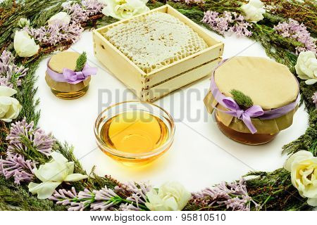 Honey Surrounded By Grass And Flowers