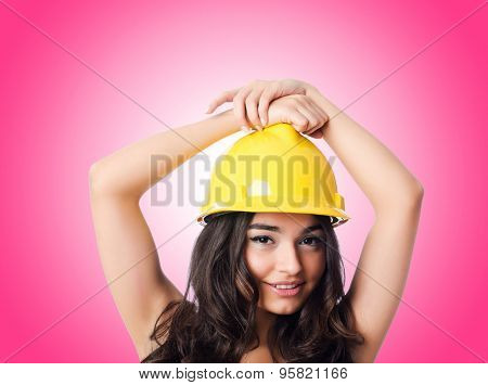 Young woman with hellow hard hat against gradient 