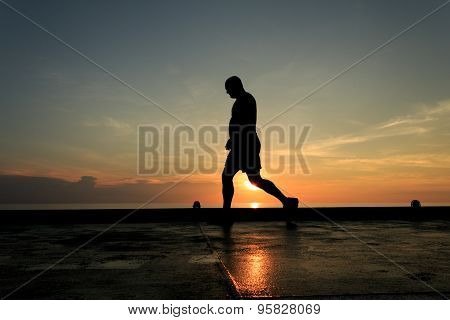 Silhouette Image Of Man Walking On The Helideck In The Evening For Excercising.
