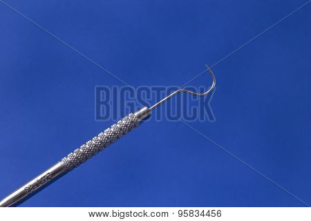 Dental explorer blue background