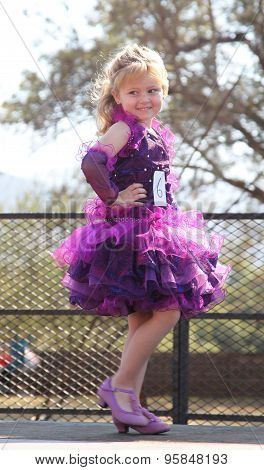 Little Blond Angel In Purple Dress At Beauty Pageant