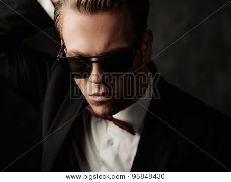 Tough sharp dressed man in black suit 