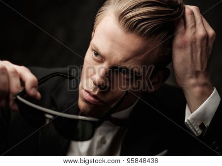 Tough sharp dressed man in black suit 