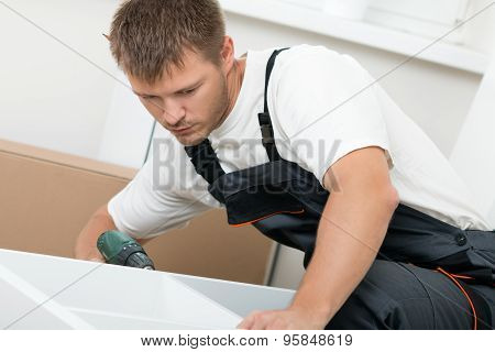 Man Putting Together Self Assembly Furniture