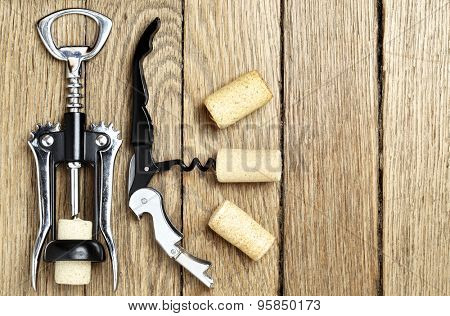 Still life with two cork-screws and wine corks with space for text